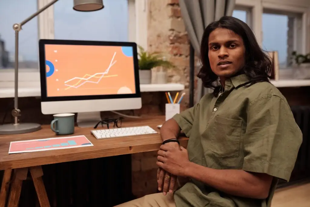 man sitting at his computer posing